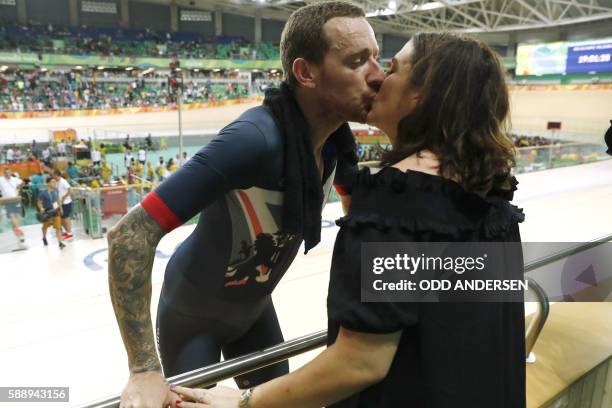 Britain's Bradley Wiggins kisses his wife Catherine Wiggins after winning gold in the men's Team Pursuit finals track cycling event at the Velodrome...