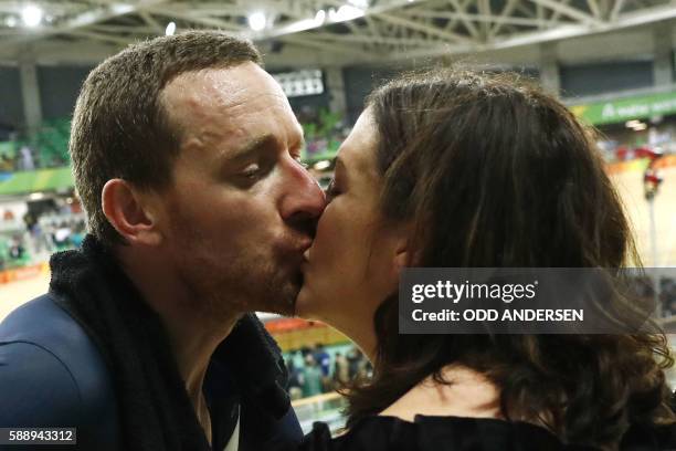 Britain's Bradley Wiggins kisses his wife Catherine Wiggins after winning gold in the men's Team Pursuit finals track cycling event at the Velodrome...