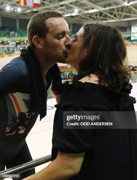 Britain's Bradley Wiggins kisses his wife Catherine Wiggins after winning gold in the men's Team Pursuit finals track cycling event at the Velodrome...