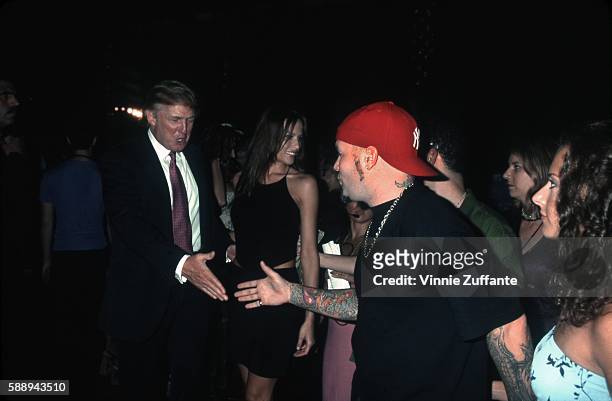 Property developer Donald Trump and girlfriend Melania Knauss greet singer Fred Durst at the 1999 MTV Video Awards at the Metropolitan Opera House on...