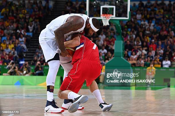 S centre DeMarcus Cousins and Serbia's shooting guard Bogdan Bogdanovic go for the ball during a Men's round Group A basketball match between USA and...