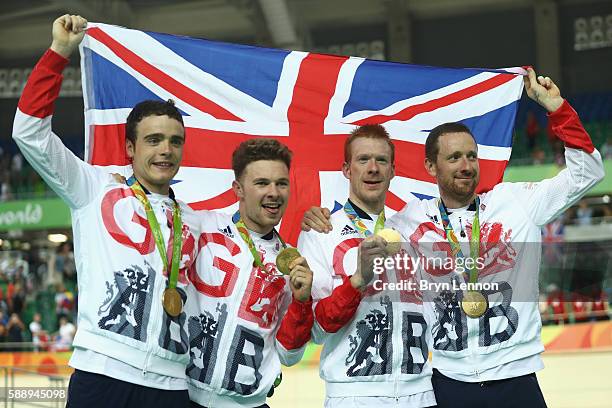 Gold medalists Steven Burke, Owain Doull, Edward Clancy and Bradley Wiggins of Team Great Britain pose for photographs after the medal ceremony for...