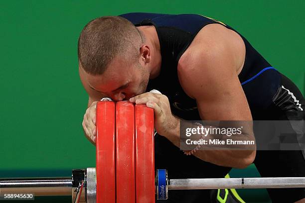 Oleksandr Pielieshenko of Ukraine kisses the weights during the Weightlifting - Men's 85kg on Day 7 of the Rio 2016 Olympic Games at Riocentro -...