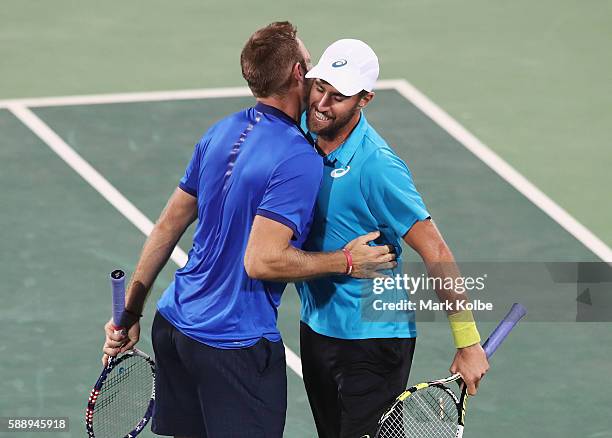 Jack Sock and Steve Johnson of the United States celebrate match point in the Men's Doubles Bronze medal match against Vasek Pospisil and Daniel...