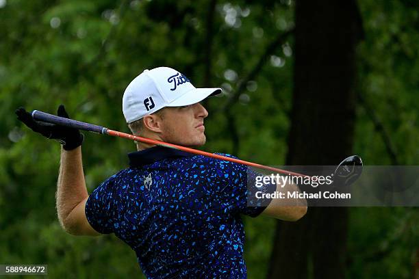 Morgan Hoffmann lets go of his golf club after a shot from the 11th tee during the second round of the John Deere Classic at TPC Deere Run on August...