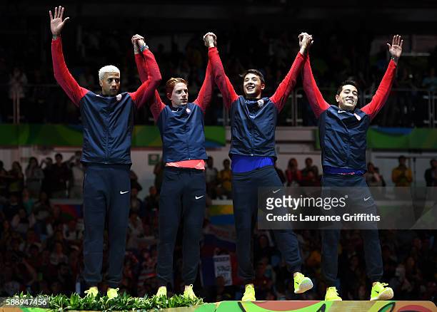 Bronze medalists Miles Chamley-Watson, Race Imboden, Alexander Massialas and Gerek Meinhardt of the United States celebrate on the podium for the...
