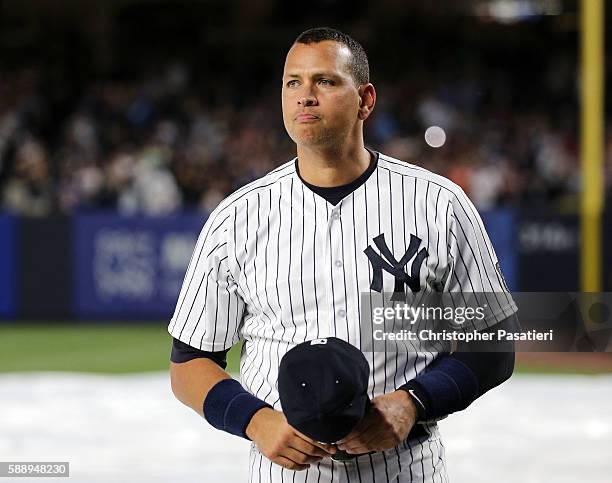 Alex Rodriguez of the New York Yankees looks on after being introduced for a ceremony honoring his retirement from baseball prior to the game against...
