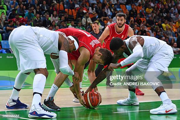 S forward Carmelo Anthony, Serbia's shooting guard Bogdan Bogdanovic and USA's guard Paul George go for the ball during a Men's round Group A...