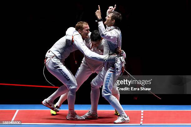 Artur Akhmatkhuzin, Timur Safin and Alexey Cheremisinov of Russia celebrate after winning gold for the Men's Team Foil event on Day 7 of the Rio 2016...