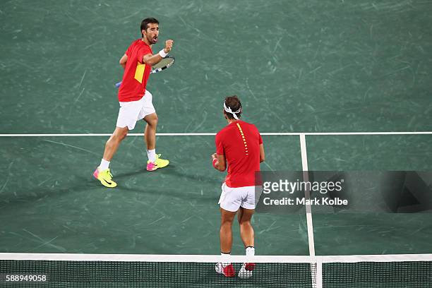 Marc Lopez and Rafael Nadal of Spain celebrate a point in the Men's Doubles Gold medal match against Horia Tecau and Florin Mergea of Romania on Day...