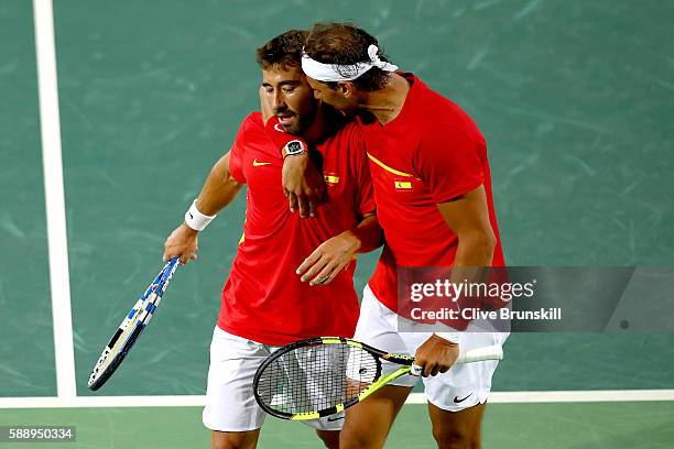 Marc Lopez and Rafael Nadal of Spain confer during the Men's Doubles Gold medal match against Horia Tecau and Florin Mergea of Romania on Day 7 of...