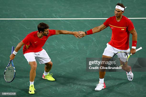 Marc Lopez and Rafael Nadal of Spain celebrate a play during the Men's Doubles Gold medal match against Horia Tecau and Florin Mergea of Romania on...