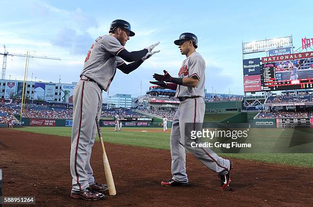 Jace Peterson of the Atlanta Braves celebrates with Mike Foltynewicz after hitting a home run in the second inning against the Washington Nationals...
