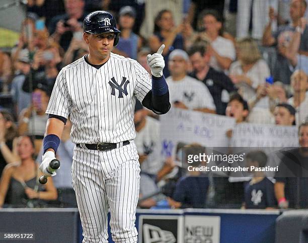 Alex Rodriguez of the New York Yankees motions towards the dugout of the Tampa Bay Rays as he comes to bat in the bottom of the first inning on...