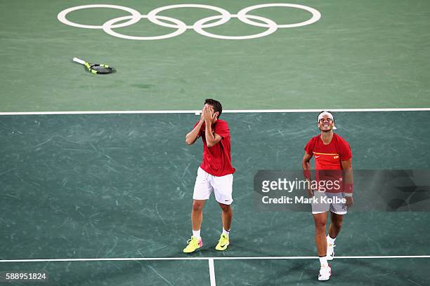 Marc Lopez and Rafael Nadal of Spain celebrate match point during the Men's Doubles Gold medal match against Horia Tecau and Florin Mergea of Romania...