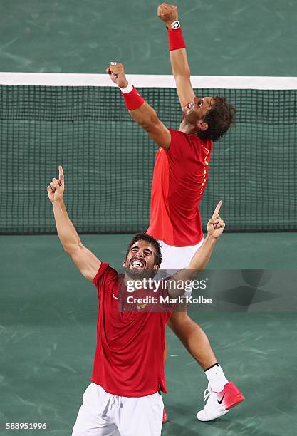 Marc Lopez and Rafael Nadal of Spain celebrate match point during the Men's Doubles Gold medal match against Horia Tecau and Florin Mergea of Romania...