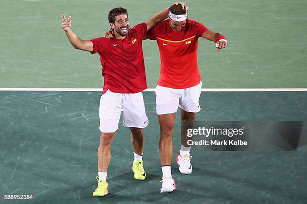 Marc Lopez and Rafael Nadal of Spain celebrate match point during the Men's Doubles Gold medal match against Horia Tecau and Florin Mergea of Romania...