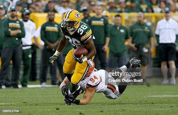 Carl Nassib of the Cleveland Browns tackles John Crockett of the Green Bay Packers in the first quarter at Lambeau Field on August 12, 2016 in Green...