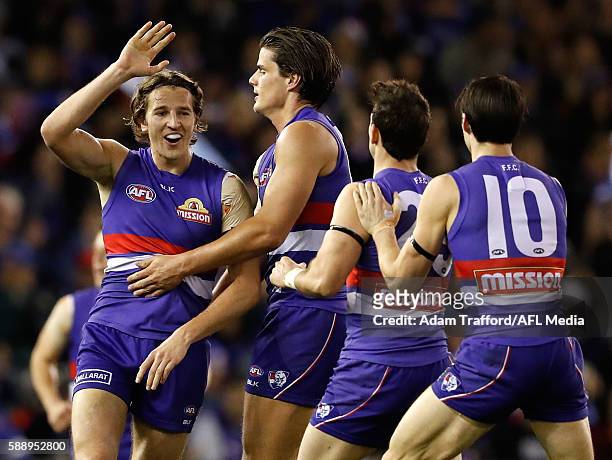 Marcus Bontempelli of the Bulldogs celebrates a goal with teammates during the 2016 AFL Round 21 match between the Western Bulldogs and the...