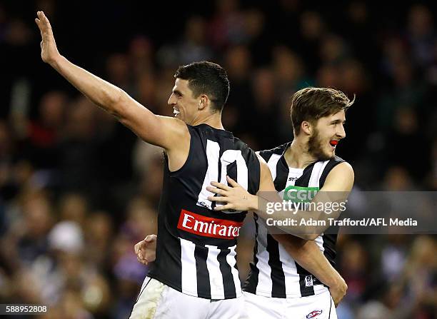 Scott Pendlebury and Tom Phillips of the Magpies celebrate during the 2016 AFL Round 21 match between the Western Bulldogs and the Collingwood...