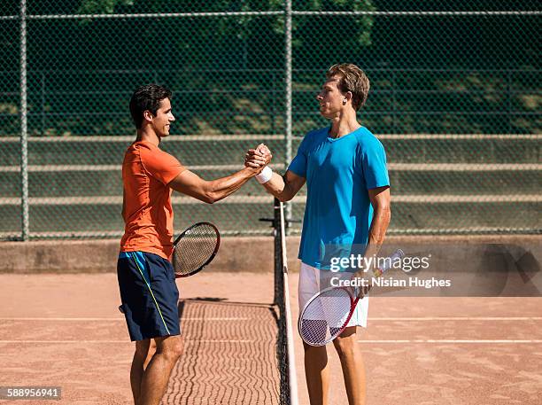 male tennis players shaking hands after match - tennis match stock pictures, royalty-free photos & images
