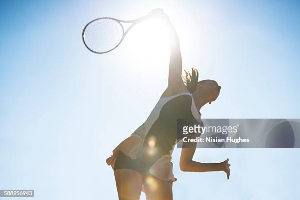 female tennis player about to hit a serve - tennis stock pictures, royalty-free photos & images