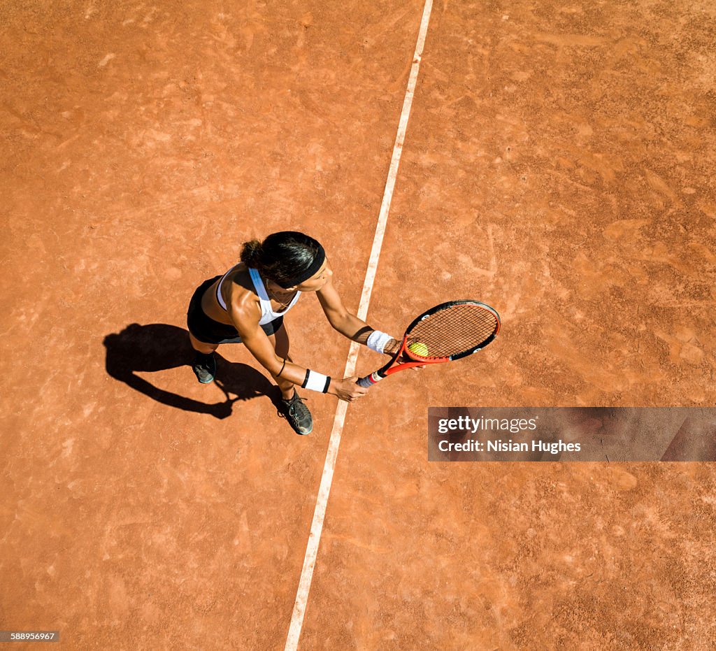 Woman tennis player about to hit a serve