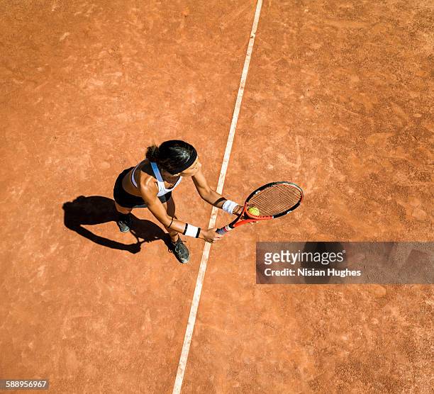 woman tennis player about to hit a serve - tennis stock-fotos und bilder