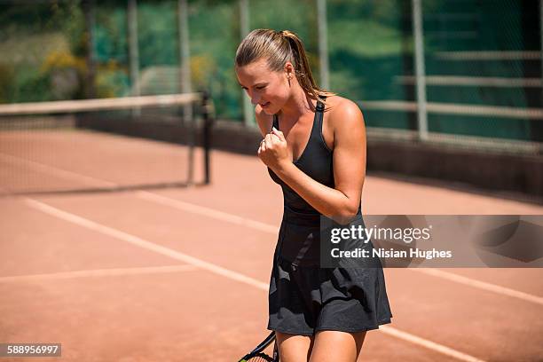 woman tennis player celebrating after winning - fist celebrating stock-fotos und bilder