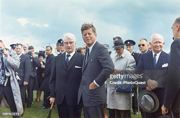 President John F Kennedy stands with unidentified others during a state visit, New Ross, County Wexford, Ireland, June 27, 1963.