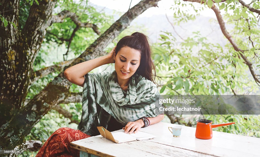 Young woman writing in the beautiful nature