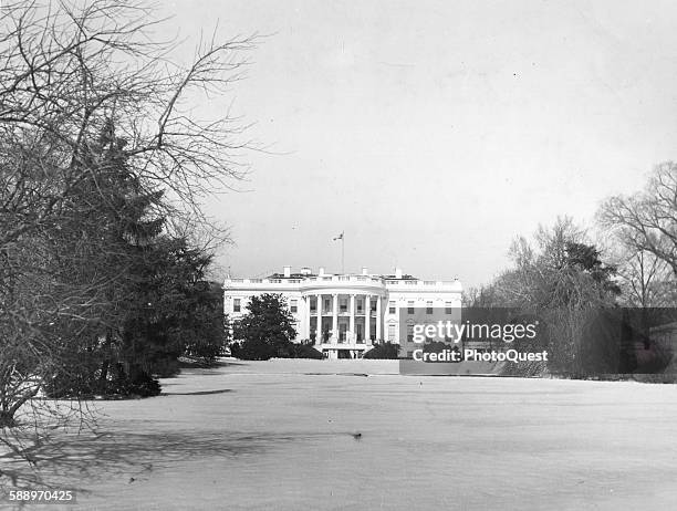 The White House, seen from the snow-covered south lawn in the winter, Washington DC, 1948.