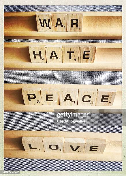 love peace war hate words spelled with scrabble tiles - 恨 個照片及圖片檔