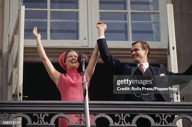 Princess Margrethe of Denmark pictured with her fiance Count Henri de Monpezat as they wave to crowds from a balcony at Amalienborg Palace in...