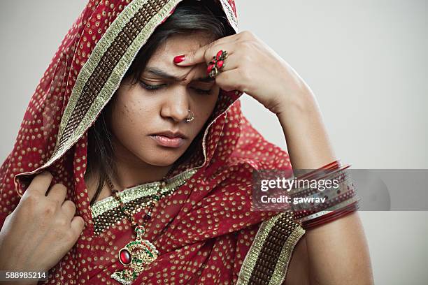 married hindu young woman holding head out of headache. - indian wife stock pictures, royalty-free photos & images