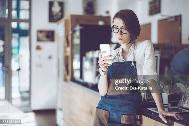 young barista is working in a café - hipster barkeeper stock pictures, royalty-free photos & images