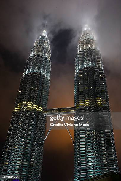 The Iconic Petronas Towers and the skybridge at night. The Petronas Twin Towers were the world's tallest buildings from 1998 to 2004, before being...