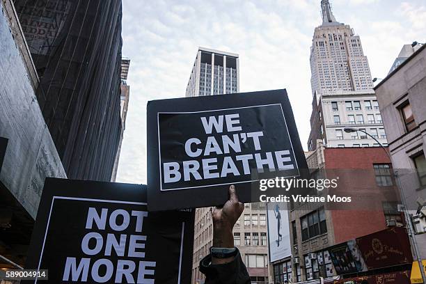 We Can't Breathe reads a sign, with the Empire State Building in the background, as Protesters take to the streets of New York and nationwide against...