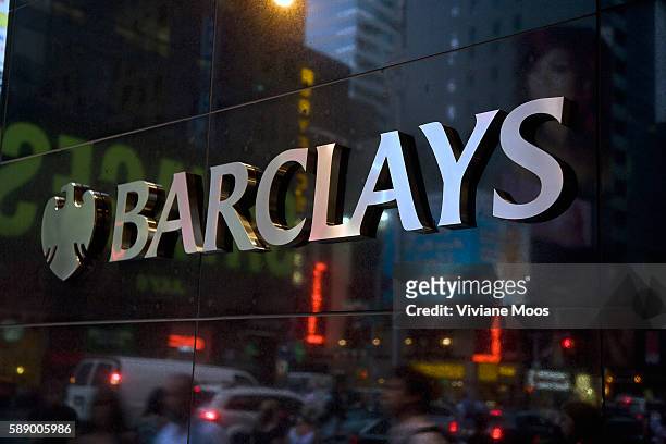 Silver logo and name of Barclays Bank with reflection of New York theatre district in the black marble wall. Moody's Investors Service has lowered...