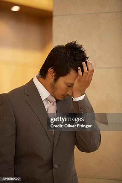 businessman with hand on face - oliver eltinger stock pictures, royalty-free photos & images