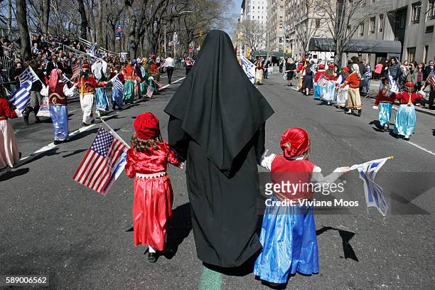 Greek-American mother and her children take part in the annual Greek Day Parade in New York's Fifth Avenue.