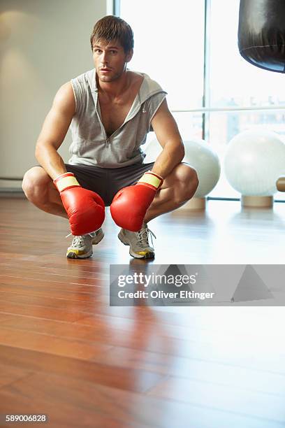 man wearing boxing gloves - oliver eltinger stock pictures, royalty-free photos & images