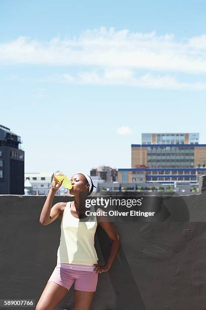 woman drinking sports drink - oliver eltinger stock pictures, royalty-free photos & images