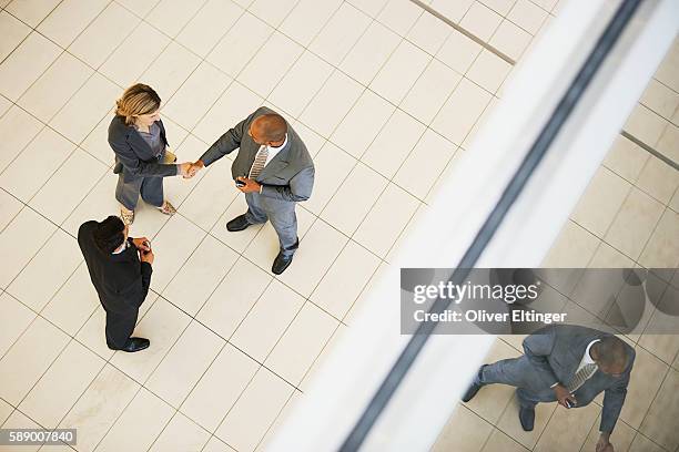 businesspeople shaking hands - oliver eltinger stock pictures, royalty-free photos & images