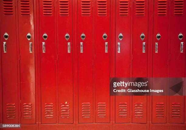 row of red lockers - locker foto e immagini stock