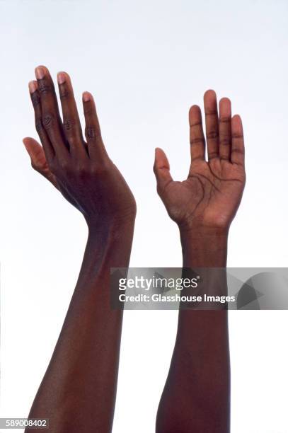 upraised arms and hands - braccio umano foto e immagini stock