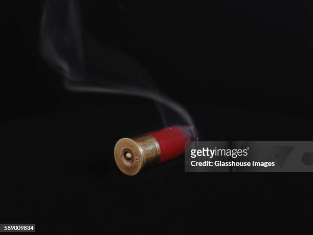 smoking shotgun shell - shotgun stock pictures, royalty-free photos & images