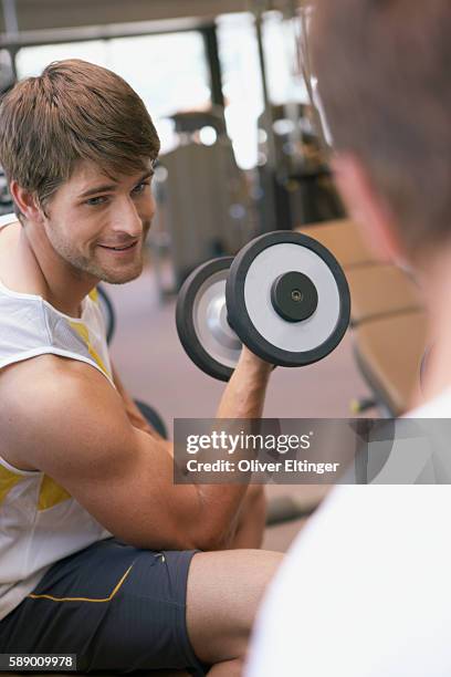 man lifting dumbbell - oliver eltinger stock pictures, royalty-free photos & images