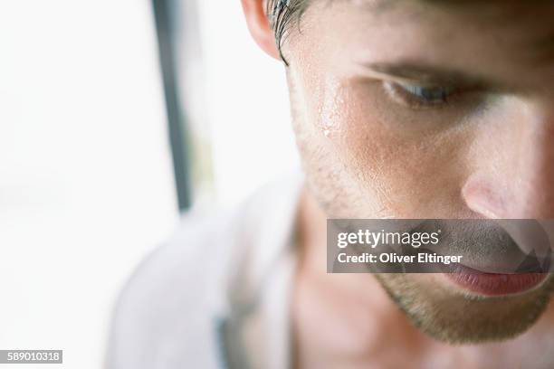 man faced with perspiration - oliver eltinger stock pictures, royalty-free photos & images