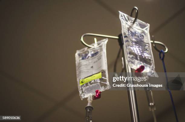 chemotherapy drugs on hospital iv pole - drip bag stockfoto's en -beelden